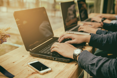 Office workers are using a notebook computer to work.