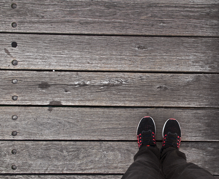 Foot wearing shoes on wooden floorの写真素材