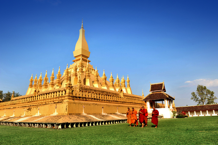 Vientiane, Laos - January 19, 2012:  Group of Buddhist monks walking around That Luang Stupa, landmark of Vientiane, Lao PDRのeditorial素材