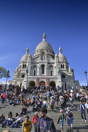 PARIS, FRANCE - 20 APRIL 2015: Tourists visiting the Basilica of the Sacred Heart of Paris, a Roman Catholic church and minor basilica, located at the summit of the butte Montmartre, the highest point of Parisのeditorial素材