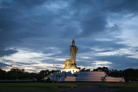 Walking Buddha statue at Buddhamonthon (Phutthamonthon), Buddhist Park in Nakhon Pathom, Thailand, in twilight momentの写真素材