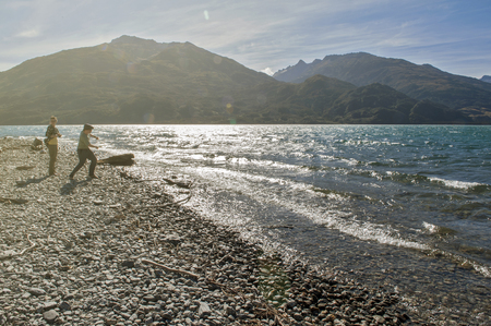 Otago, New Zealand - February 2016 : Tourists strolling around Lake Wanaka in the late afternoon.のeditorial素材