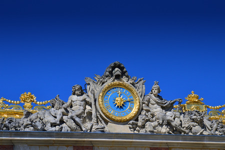 VERSAILLES, FRANCE - April 19, 2015: Beautiful roof details with golden ornaments and statues of Palace of Versaillesのeditorial素材
