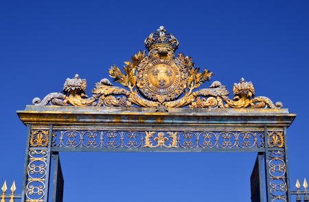 VERSAILLES, FRANCE - April 19, 2015: Golden Main Gates of the Versailles Palace. The Palace...