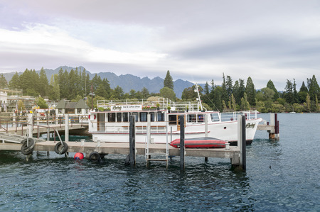 Queenstown, New Zealand - March 2016: Boat piers at Queenstown lakefront by Lake Wakatipu, New Zealandのeditorial素材