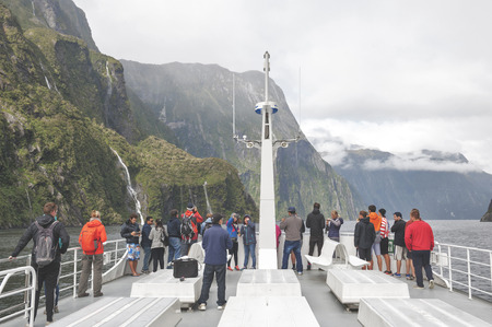 Milford Sound, New Zealand - February 2016: Tourists on boat cruises in the fjord of Milford Sound, South island of New Zealandのeditorial素材