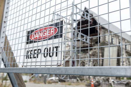 Christchurch, New Zealand - February 2016: Keep out sign in front of badly damaged Christchurch Cathedral by the 2011 earthquake at the Cathedral Square in Christchurch Centralのeditorial素材