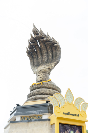 Statue of Seven-headed Serpent located by the Mekong River in downtown Nakhon Phanom, Thailand. White background with space.のeditorial素材