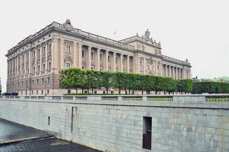 Building of The Parliament House of Sweden built in Neoclassical style, with a centered Baroque Revival style facade section, located on nearly half of Helgeandsholmen island, in the Gamla stan, old town district of central Stockholmのeditorial素材