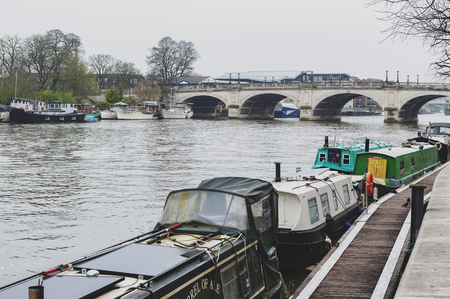 Kingston upon Thames, United Kingdom - April 2018: Local boat docking at Riverside Walk promenade by the River Thames in Kingston, Englandのeditorial素材