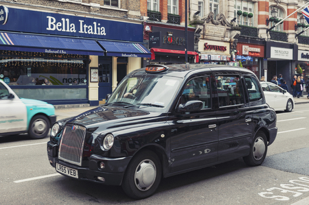 London, UK - April 2018: London taxi cab driven on Shaftesbury Avenue, a major street in the West End of London near Piccadilly Circus, city of Westminsterのeditorial素材