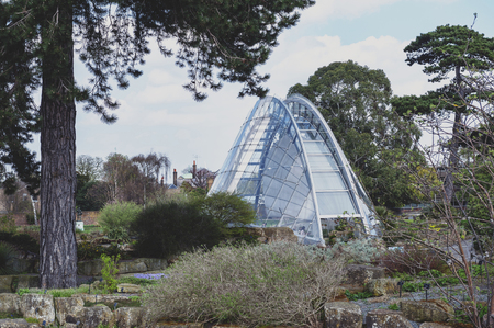 London, UK - April 2018: Davies Alpine House, modern building designed to provide perfect condition for alpine plants, located in Kew Gardens, London, Englandのeditorial素材