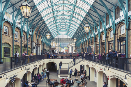 London, UK - April 2018: Interior of Covent Garden Market, a place for fashionable retail stores and dining on popular tourist site surrounded by historical buildings, theatres and entertainment facilities in Westminster City, Greater Londonのeditorial素材