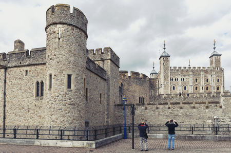 London, UK - April 2018: Exterior view of Her Majesty's Royal Palace and Fortress of the Tower of London, a historic castle and popular tourist attraction located on the north bank of the River Thames in central London, Englandのeditorial素材