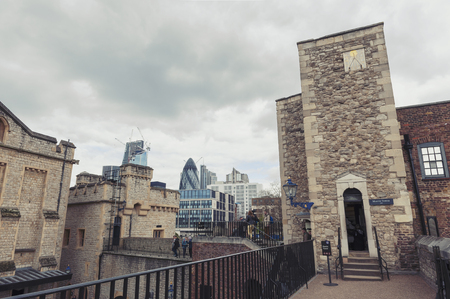 London, UK - April 2018: Old buildings and towers in the inner ward area of Royal Palace and Fortress of the Tower of London, a historic castle and popular tourist attraction located on the north bank of the River Thames in central London, Englandのeditorial素材
