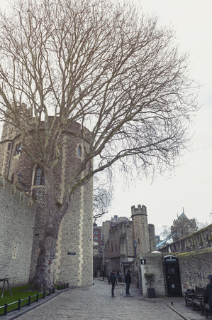 London, UK - April 2018: Old buildings and towers in the inner ward area of Royal Palace and Fortress of the Tower of London, a historic castle and popular tourist attraction located on the north bank of the River Thames in central London, Englandのeditorial素材
