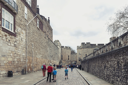 London, UK - April 2018: Old buildings and towers in the inner ward area of Royal Palace and Fortress of the Tower of London, a historic castle and popular tourist attraction located on the north bank of the River Thames in central London, Englandのeditorial素材