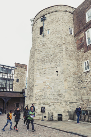 London, UK - April 2018: Old buildings and towers in the inner ward area of Royal Palace and Fortress of the Tower of London, a historic castle and popular tourist attraction located on the north bank of the River Thames in central London, Englandのeditorial素材