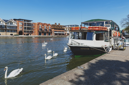 Berkshire, UK - April 2018: Tourist boat cruise at a pier by the River Thames located between the towns of Windsor and Eton in Berkshireのeditorial素材