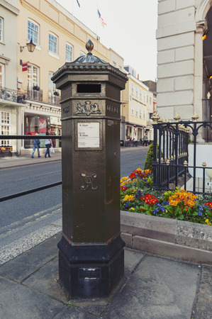 Windsor, UK - April 2018: Early UK pillar box, a free-standing post box to be collected by the Royal Mail of United Kingdom, situated on High Street of Windsor, Berkshire, Englandのeditorial素材