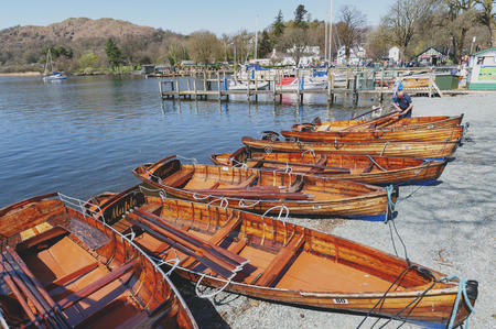 South Lakeland, UK - April 2018: Rowing boat at Waterhead Pier in Ambleside, a lakeside town situated at the head of Windermere Lake within the Lake District National Park in Englandのeditorial素材