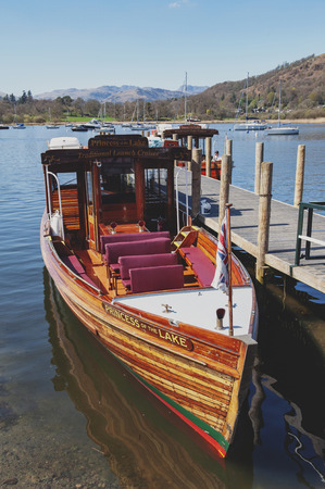 South Lakeland, UK - April 2018: Tourist boat cruise at Waterhead Pier in Ambleside, a lakeside town situated at the head of Windermere Lake within the Lake District National Park in Englandのeditorial素材