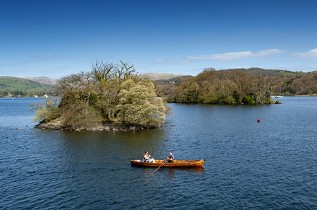 South Lakeland, UK - April 2018: Tourists rowing boat on scenic Lake Windermere in Lake District National Park, North West England, UKのeditorial素材