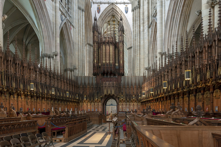 York, England - April 2018: The choir with the organ on the choir screen and elaborately carved choir stalls inside York Minster, historic cathedral built in English gothic architectural style and major tourist landmark of the City of York in England, UKのeditorial素材