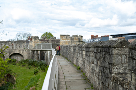 York, England - April 2018: Elevated walkway on York City Walls, (Bar Walls or Roman walls), ancient monument encircling historic City of York, England, UKのeditorial素材