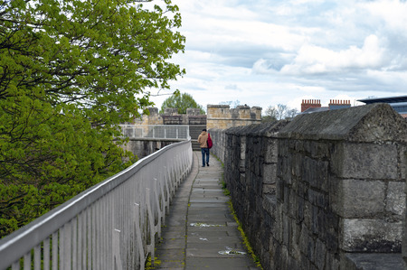 York, England - April 2018: Elevated walkway on York City Walls, (Bar Walls or Roman walls), ancient monument encircling historic City of York, England, UKのeditorial素材