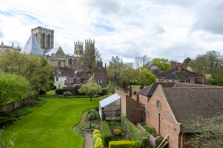 York, England - April 2018: York Minster, historic cathedral built in English gothic style, and buildings in old town seen from York City Walls in City of York, England, UKのeditorial素材