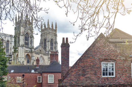 York, England - April 2018: York Minster, historic cathedral built in English gothic style, and buildings in old town seen from York City Walls in City of York, England, UKのeditorial素材