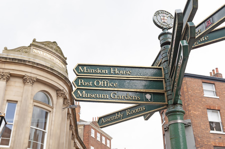 York, England - April 2018: Direction signpost on street in historic district of City of York,...