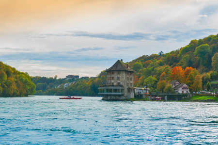 Schaffhausen, Switzerland - October 2019: Sightseeing boat taking tourists to the Rhine Falls, famous and biggest waterfall in Europe on the Rhine River in Switzerlandのeditorial素材