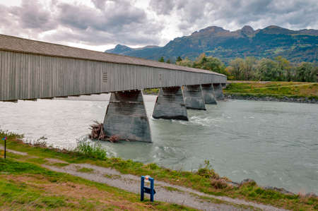 Vaduz, Liechtenstein - October 2019: The Alte Rheinbrücke, an old wooden roofed bridge over the river Rhine on border between municipalities of Vaduz in Liechtenstein and Sevelen in Switzerlandのeditorial素材