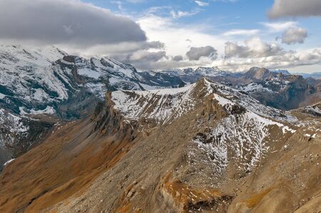 Scenic view of snow-capped mountains of the Swiss Alps skyline seen from the Schilthorn, a summit in the Bernese Alps above the village of Murren in Lauterbrunnen, Switzerlandの写真素材