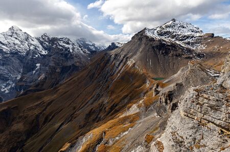 Scenic view of snow-capped mountains of the Swiss Alps skyline seen from the Schilthorn, a summit in...