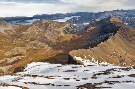 Scenic view of snow-capped mountains of the Swiss Alps skyline seen from the Schilthorn, a summit in the Bernese Alps above the village of Murren in Lauterbrunnen, Switzerlandの写真素材