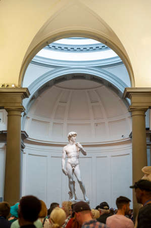 Florence, Italy - October 2019: A crowd of visitors gathering in the Galleria dell'Accademia di Firenze (Gallery of the Academy of Florence) to see the famous marble statue of David by Michelangeloのeditorial素材