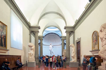 Florence, Italy - October 2019: A crowd of visitors gathering in the Galleria dell'Accademia di Firenze (Gallery of the Academy of Florence) to see the famous marble statue of David by Michelangeloのeditorial素材