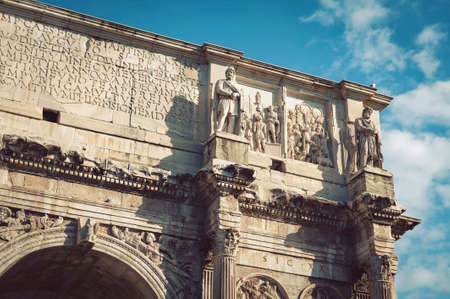 Close-up details of relief panels, round reliefs, and frieze on the attic of The Arch of...