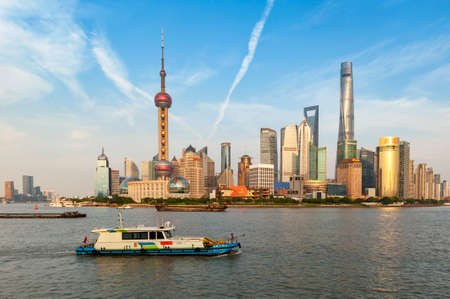 Shanghai, China - September 2019: Skyscrapers over city skyline of Shanghai at the financial and business district of Lujiazui (Lokatse) in Pudong New Area, viewed from The Bund on the opposite side of Huangpu River in Shanghai, Chinaのeditorial素材
