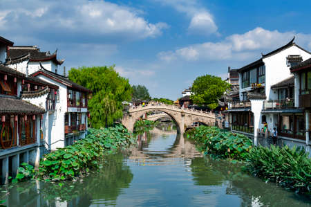 Shanghai, China - September 2019: Traditional Chinese teahouses and buildings along the riverbank of the Puhui River in Qibao Ancient Town, a historic water township of Qibao in the Minhang District of Shanghai, Chinaのeditorial素材
