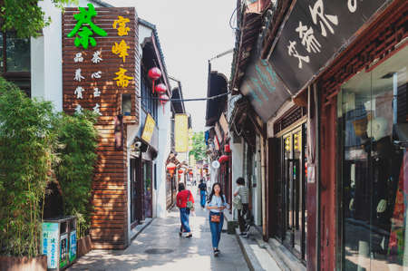 Shanghai, China - September 2019: Buildings and shophouses built in traditional Chinese architecture style located along the Qibao Old Street in Qibao Ancient Town, a historic water township of Qibao in the Minhang District of Shanghai, Chinaのeditorial素材