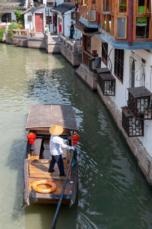 Shanghai, China - September 2019: Sightseeing tour on Chinese traditional rowboat along the canal in Zhujiajiao Ancient Water Town, a historic village and famous tourist destination in the Qingpu District of Shanghai, Chinaのeditorial素材