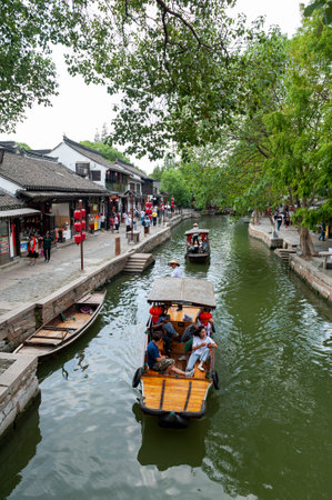 Shanghai, China - September 2019: Sightseeing tour on Chinese traditional rowboat along the canal in Zhujiajiao Ancient Water Town, a historic village and famous tourist destination in the Qingpu District of Shanghai, Chinaのeditorial素材