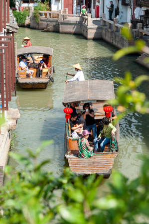 Shanghai, China - September 2019: Sightseeing tour on Chinese traditional rowboat along the canal in Zhujiajiao Ancient Water Town, a historic village and famous tourist destination in the Qingpu District of Shanghai, Chinaのeditorial素材