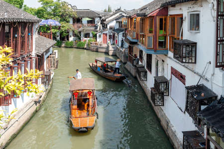 Shanghai, China - September 2019: Sightseeing tour on Chinese traditional rowboat along the canal in Zhujiajiao Ancient Water Town, a historic village and famous tourist destination in the Qingpu District of Shanghai, Chinaのeditorial素材