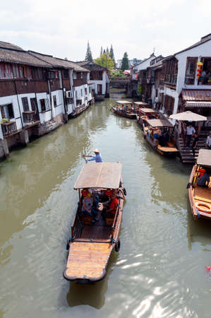 Shanghai, China - September 2019: Sightseeing tour on Chinese traditional rowboat along the canal in Zhujiajiao Ancient Water Town, a historic village and famous tourist destination in the Qingpu District of Shanghai, Chinaのeditorial素材