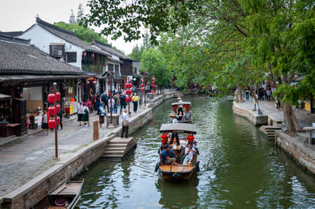Shanghai, China - September 2019: Sightseeing tour on Chinese traditional rowboat along the canal in Zhujiajiao Ancient Water Town, a historic village and famous tourist destination in the Qingpu District of Shanghai, Chinaのeditorial素材